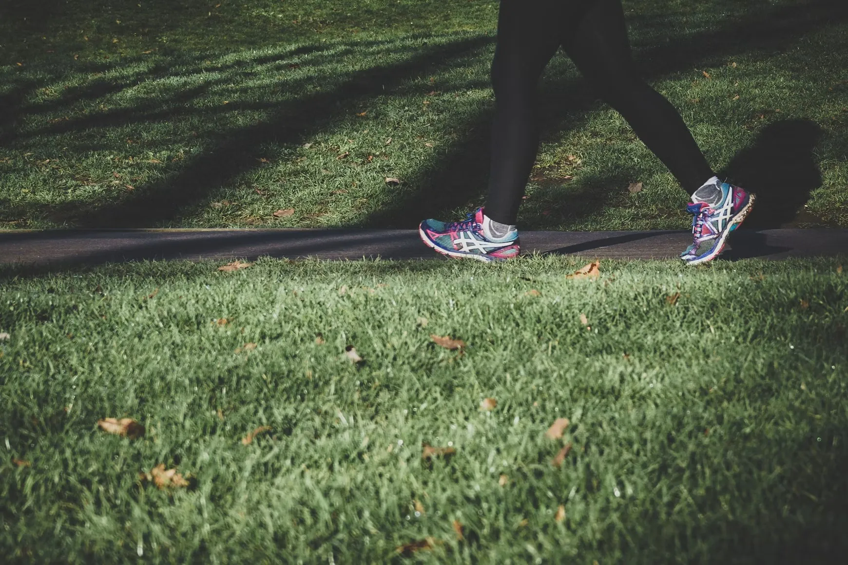 A person walking along a path beside grass, illustrating daily activities to discuss after an appointment