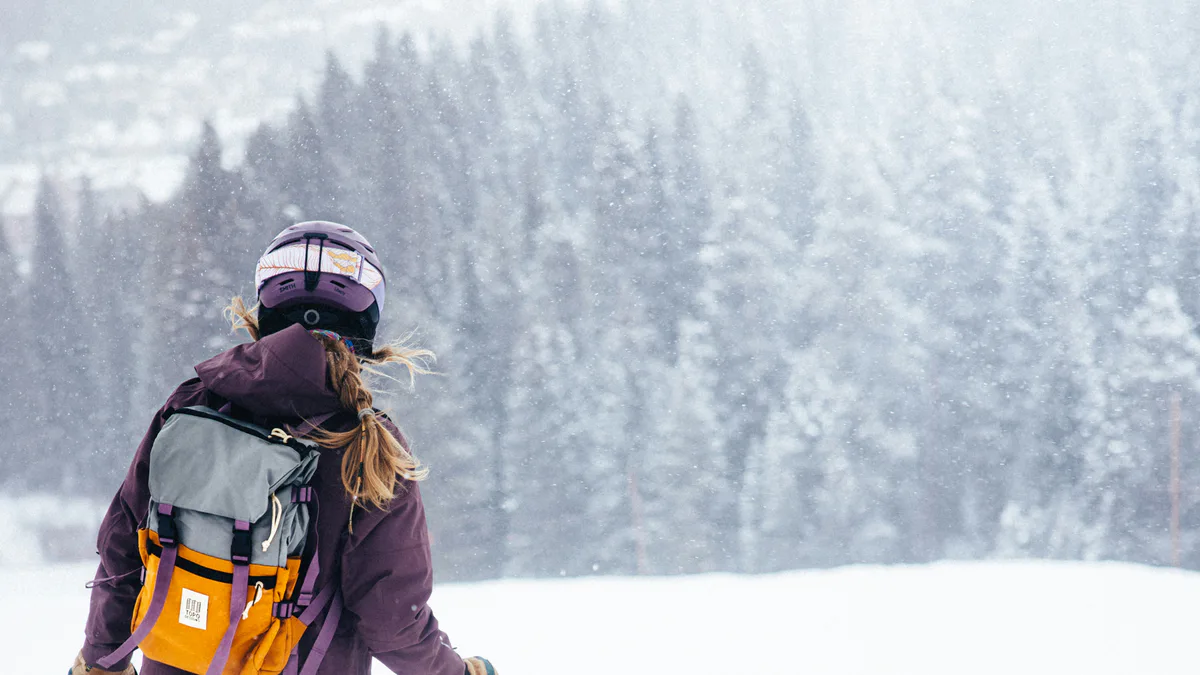 Skier in winter gear on a snowy slope