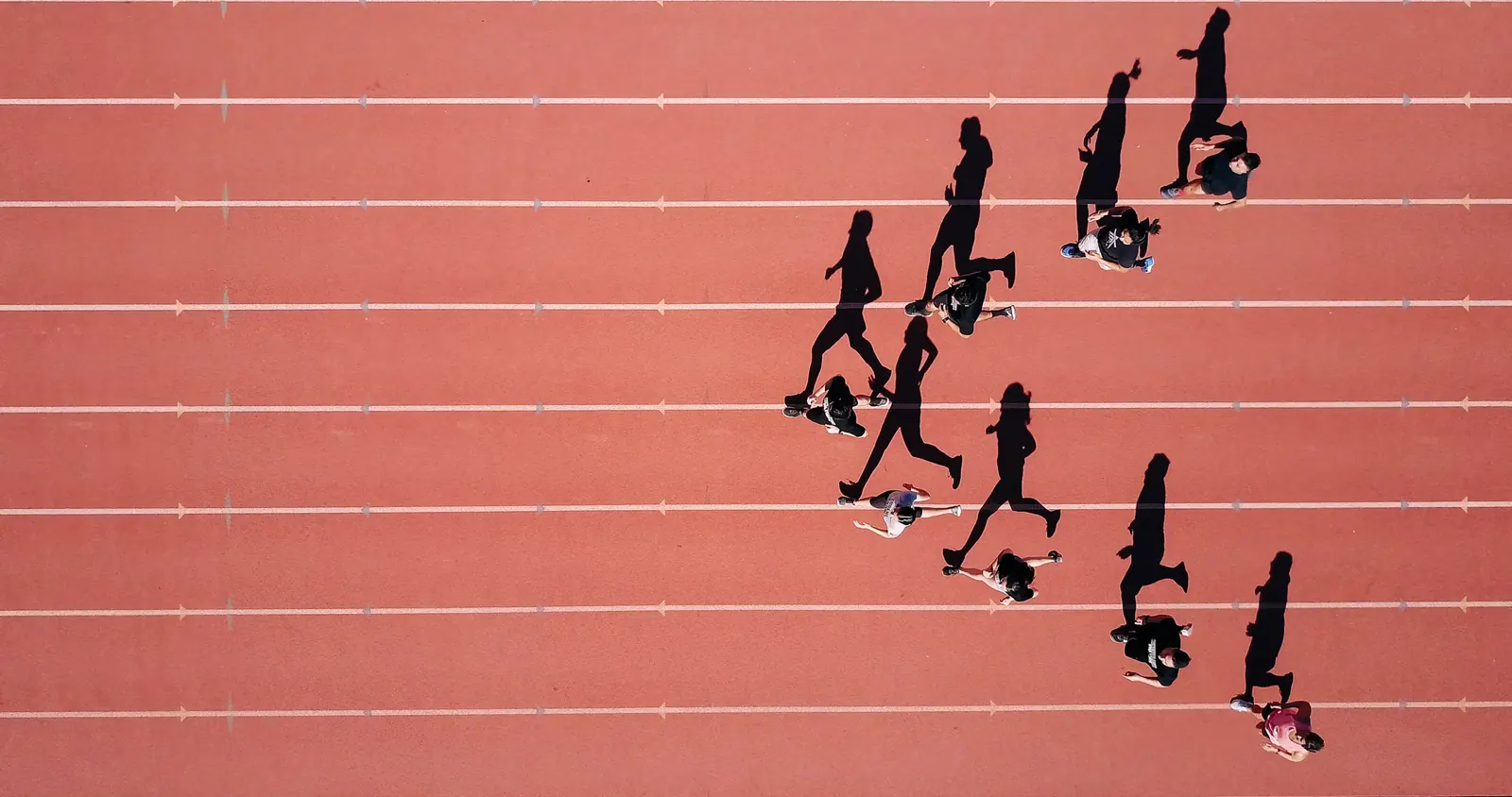 Vue de dessus de coureurs sur une piste, en illustration du retour à l’entraînement après une blessure musculaire