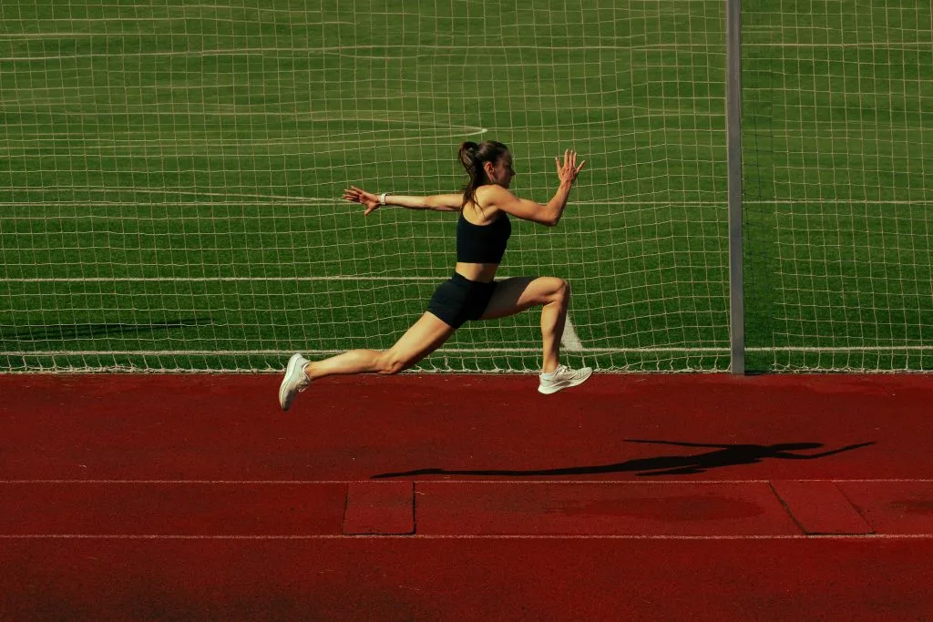 Runner training on a track, illustrating the demands involved in a return to sport